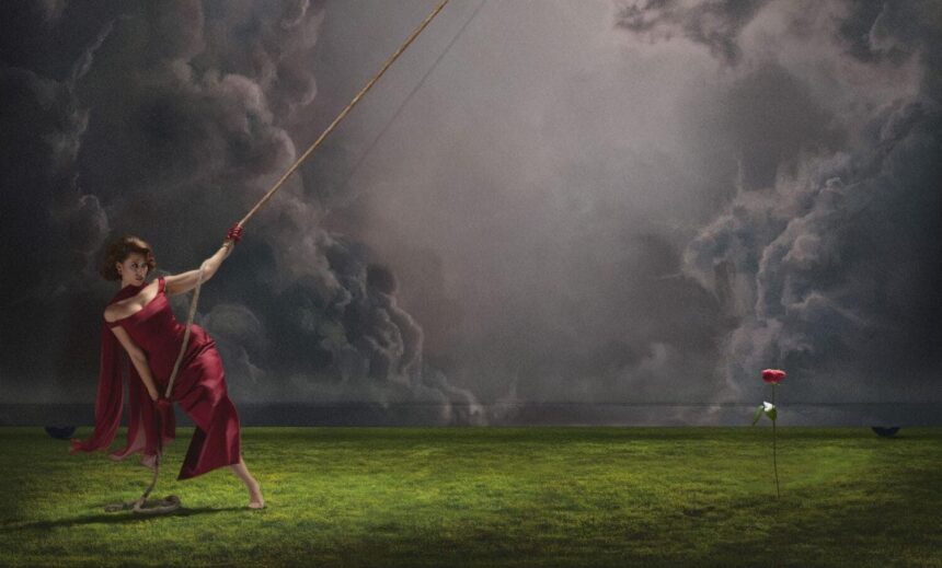 `RAYE pulling a rope against storm clouds, 'This Music May Contain Hope' (2026)`