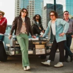 Silverada posed in front of a vintage Texas Cadillac with the Austin skyline, 2026 press photo.
