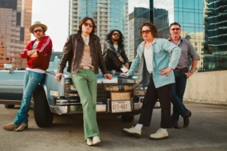 Silverada posed in front of a vintage Texas Cadillac with the Austin skyline, 2026 press photo.