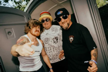 Three members of Sublime posing backstage at a live event.