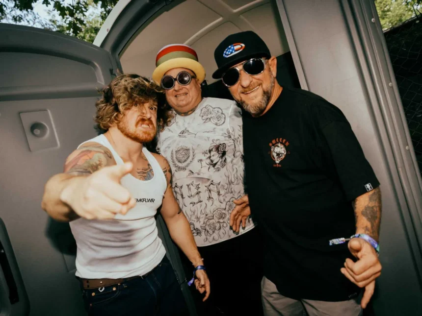 Three members of Sublime posing backstage at a live event.