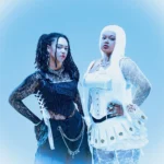 `ALT BLK ERA sisters Nyrobi and Chaya Beckett-Messam posing in contrasting black and white outfits, promoting their 'Our World' EP and 'Silhouettes In The Mirror' single.`