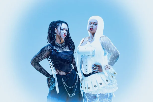 `ALT BLK ERA sisters Nyrobi and Chaya Beckett-Messam posing in contrasting black and white outfits, promoting their 'Our World' EP and 'Silhouettes In The Mirror' single.`