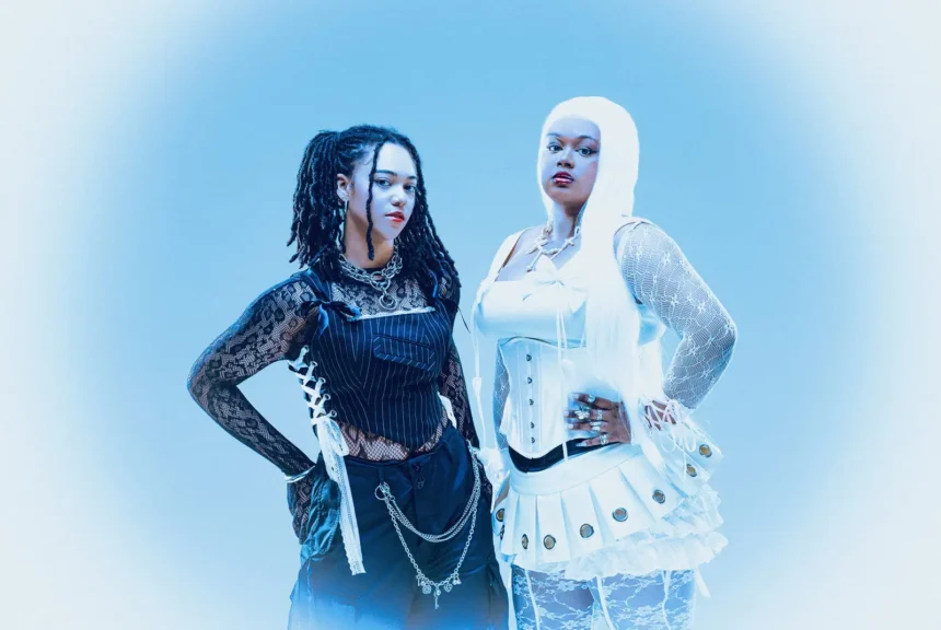 `ALT BLK ERA sisters Nyrobi and Chaya Beckett-Messam posing in contrasting black and white outfits, promoting their 'Our World' EP and 'Silhouettes In The Mirror' single.`