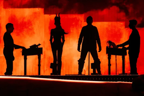 Nine Inch Noize performing live at Coachella 2026, four silhouettes against a blood-red smoke-filled stage