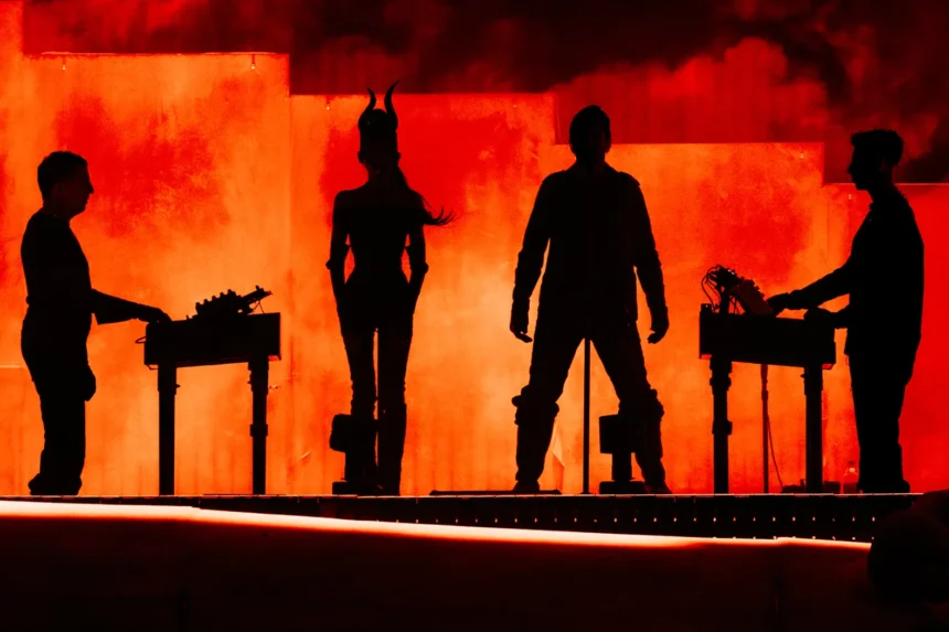 Nine Inch Noize performing live at Coachella 2026, four silhouettes against a blood-red smoke-filled stage