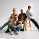 American Football pose in a bright white studio for their LP4 press photo, ahead of the album's May 1, 2026 release via Polyvinyl - LateTown