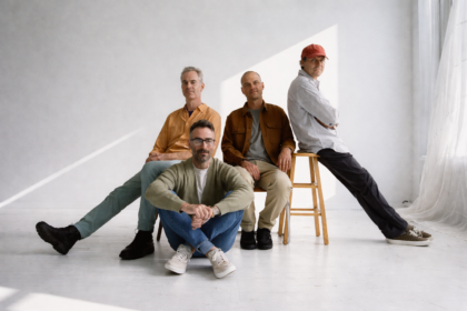 American Football pose in a bright white studio for their LP4 press photo, ahead of the album's May 1, 2026 release via Polyvinyl - LateTown