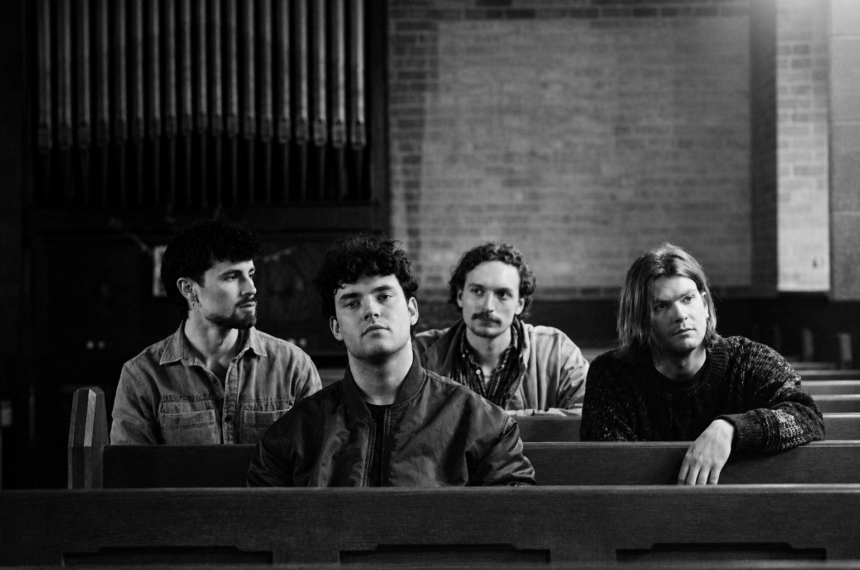 Basht sit in a dim, church-like space as they announce their debut album Poor Advice, arriving in October, alongside the lead single “Perfume.”