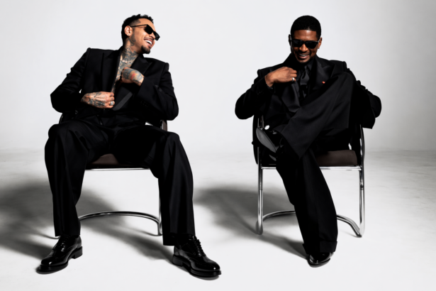 Chris Brown and Usher seated in chairs wearing black suits, laughing, R&B Tour 2026 press photo