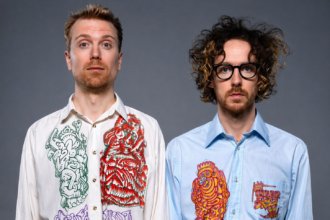 Ciao Lucifer duo posing in psychedelic illustrated shirts against a gray background - LateTown