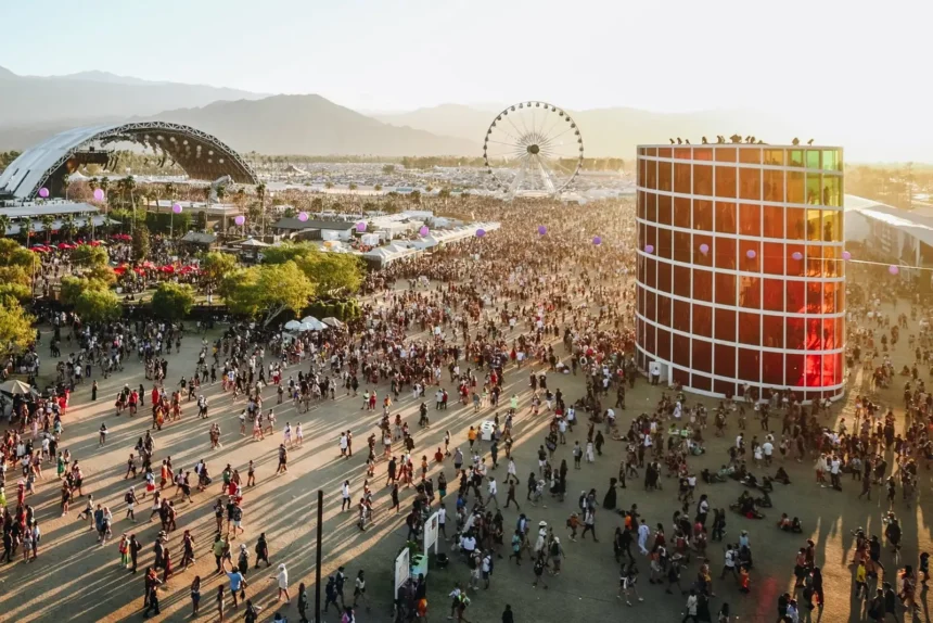 Aerial view of Coachella festival grounds at sunset, with crowds, the main stage, and Ferris wheel at Empire Polo Club, Indio, California