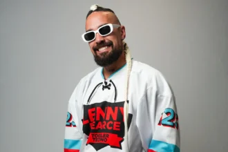 Lenny Pearce, Australian DJ behind the Disney Jr. Toddler Techno deal, wearing his signature Toddler Techno jersey and white sunglasses