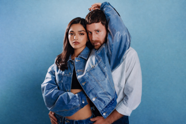 Rachel Zegler and Ben Platt pose together in matching denim jackets against a blue background for The Last Five Years 25th Anniversary live album press photo