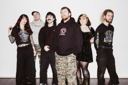 Sincere Engineer pose together against a white wall for a band promo photo ahead of their fourth album 'Probable Claws'