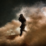 Soldier amidst smoke and shadows