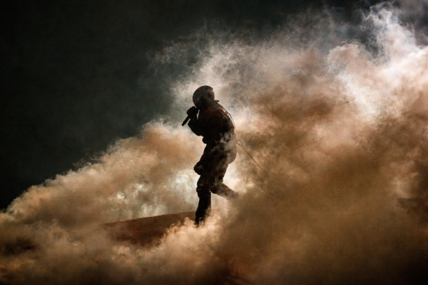 Soldier amidst smoke and shadows