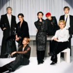 ATEEZ posing for an elegant high-fashion group portrait in black and white outfits during an editorial photoshoot ahead of their BST Hyde Park 2026 UK headline show