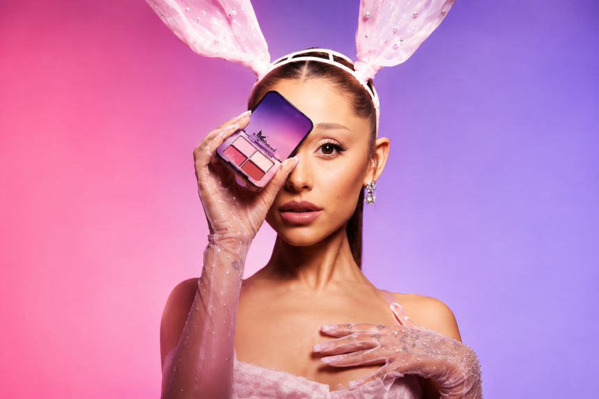 `Ariana Grande poses in pink bunny ears and sheer gloves, holding a r.e.m. beauty blush palette, in a promotional image tied to the 'Dangerous Woman' 10th anniversary era.`