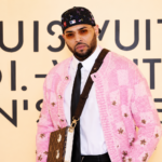 Chris Brown at Louis Vuitton event in pink cardigan and LV bag, ahead of Brown album release May 2026