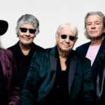 Deep Purple official press photo for 'Splat!' — five band members posed against a white studio background, wearing dark blazers and sunglasses