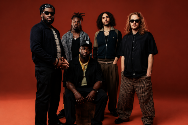 Ezra Collective five-piece band in a 2026 press photo against a red background