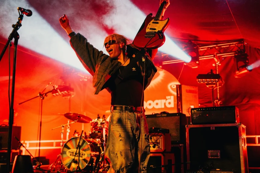 `Keo's Finn Keogh raises his guitar triumphantly on the Billboard U.K. stage at The Great Escape Festival 2026 in Brighton.`
