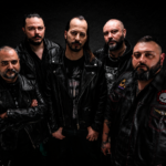 LIPFORD and Neverhush band members pose in leather jackets against a dark studio backdrop for their 2026 single 'The Music'