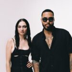 TroyBoi and Daya pose together in matching black outfits against a white backdrop for their 2026 single HUSH on Ultra Records