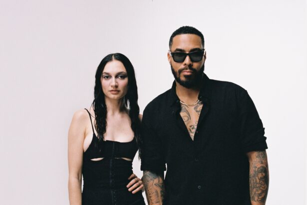 TroyBoi and Daya pose together in matching black outfits against a white backdrop for their 2026 single HUSH on Ultra Records