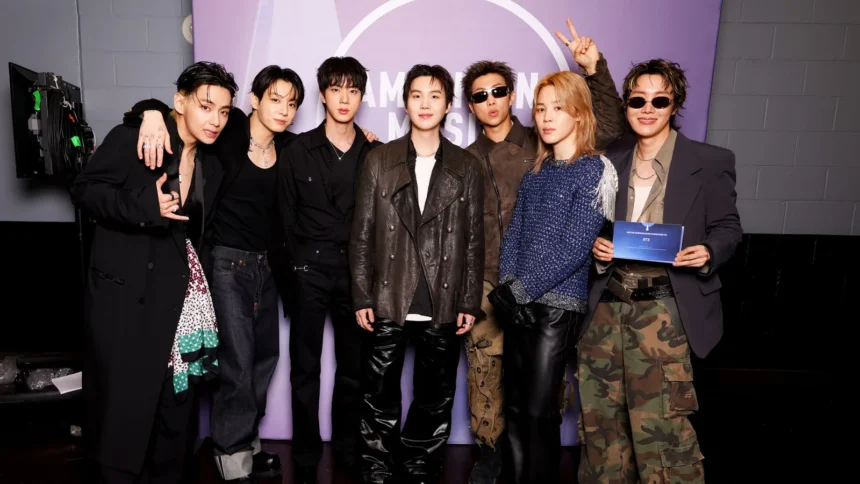 BTS all seven members RM Jin Suga j-hope Jimin V Jung Kook at 2026 American Music Awards backstage ahead of BTS Lyrics Inside and BTS Recipe Book announcement