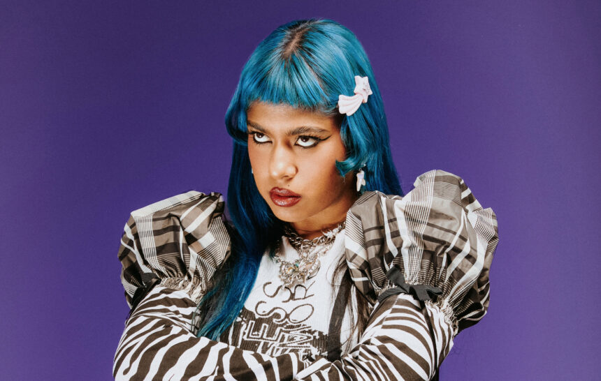 Ecca Vandal with signature blue hair and bold makeup photographed by Brianna Alysse for her NME June 2026 cover story on second album Looking For People To Unfollow