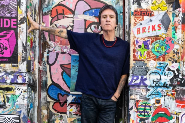 Johnny Marr official press photo for The Age Of Everything fifth solo album BMG October 2026 photographed against street art wall
