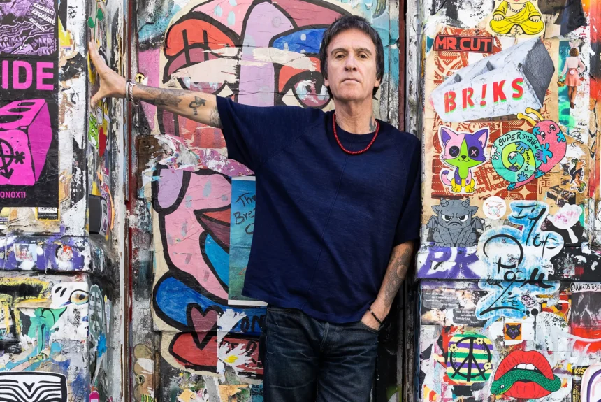 Johnny Marr official press photo for The Age Of Everything fifth solo album BMG October 2026 photographed against street art wall
