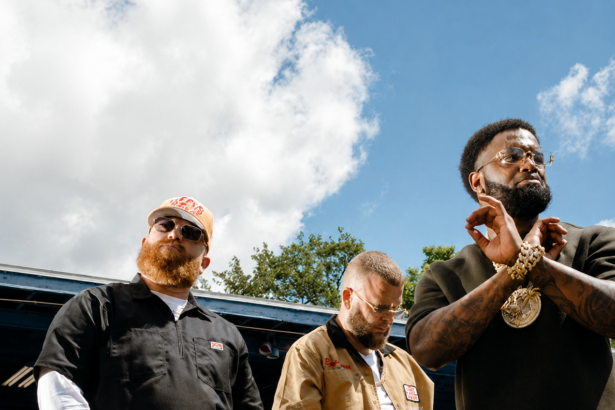 Sam E Hues and Nino Breeze pose beside a classic car in a bold outdoor shot promoting their Gulf Coast anthem, "Chrome."