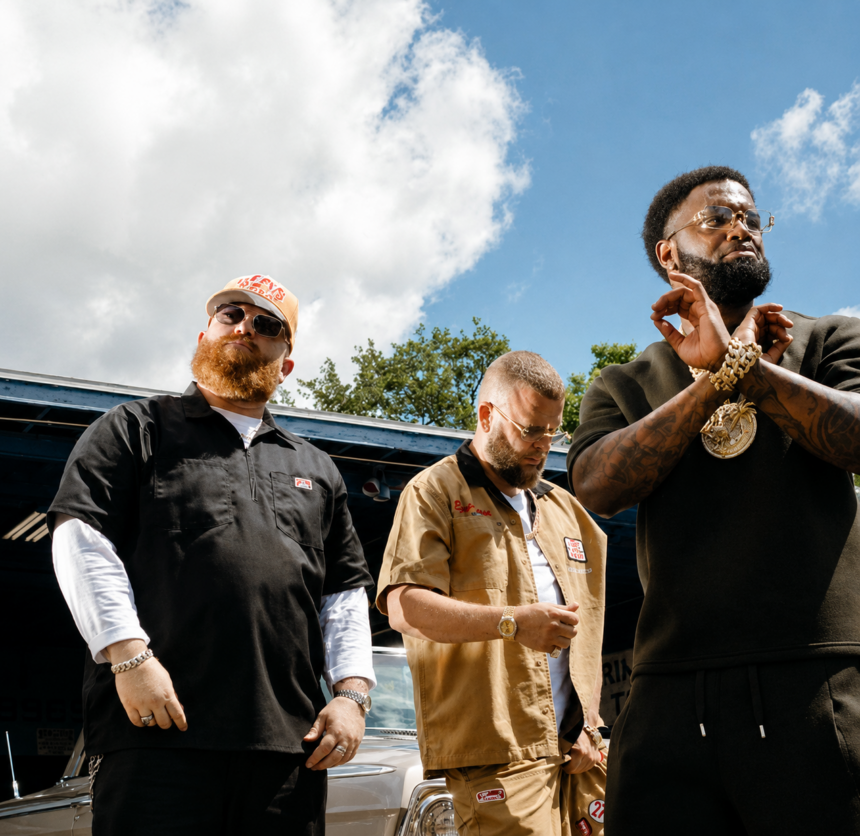 Sam E Hues and Nino Breeze pose beside a classic car in a bold outdoor shot promoting their Gulf Coast anthem, "Chrome."