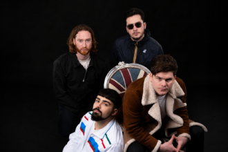 Stereo Silence Surrey UK indie rock band official press photo for Old Pair of Shoes single June 2026 featuring Union Jack chair