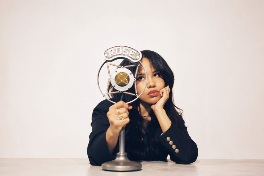Baby Rose poses with a vintage Rose-branded microphone in a press photo for her album 'YEARNALISM'