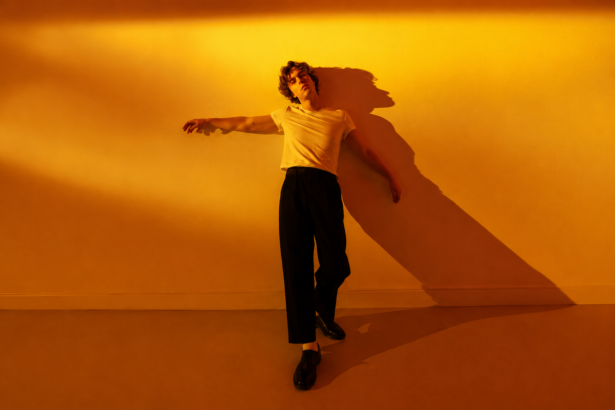Alfie Jukes Brighton indie pop singer songwriter official press photo for Edges of You new single July 2026 Royal Shakespeare Company background
