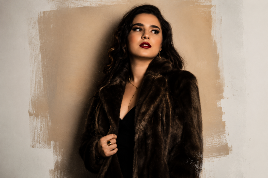 Singer Allison Amber Hage in a fur coat and red lipstick, evoking the classic vocal era behind her single Captured My Heart