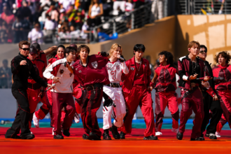 BTS members perform Dynamite in red and black outfits with dancers during the 2026 FIFA World Cup final halftime show