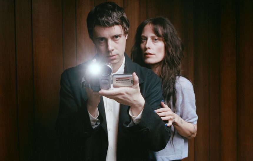 Boy Harsher's Augustus Muller and Jae Matthews pose with a vintage camcorder for their album Get Mean