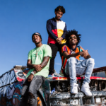 Bay Area rap group SOB X RBE pose atop a graffiti-covered car in a press photo for their reunion.