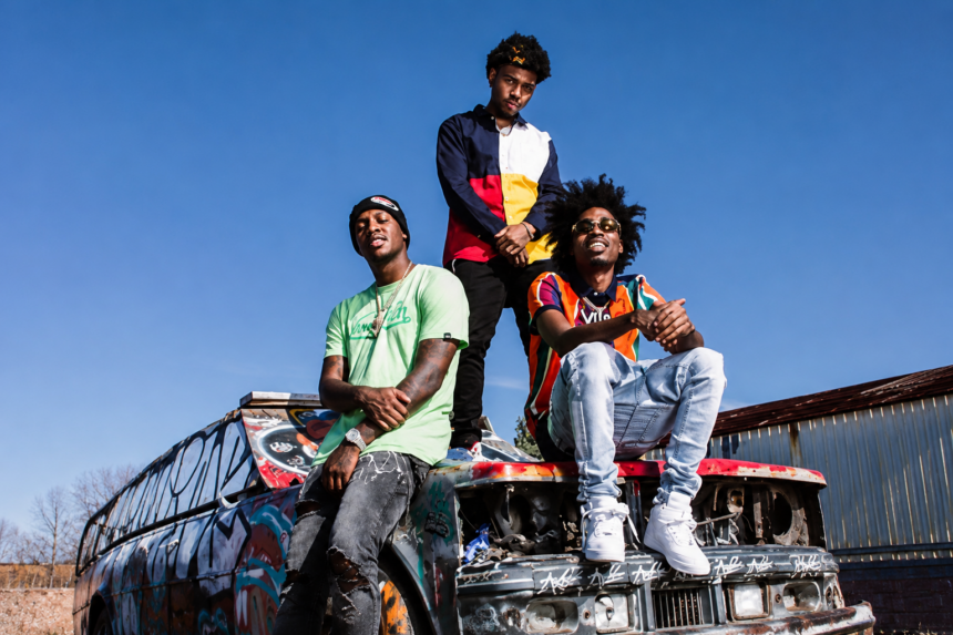 Bay Area rap group SOB X RBE pose atop a graffiti-covered car in a press photo for their reunion.