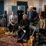 Teenage Fanclub photographed in black and white at Black Bay Studio surrounded by guitars, drums and a Moog synthesizer