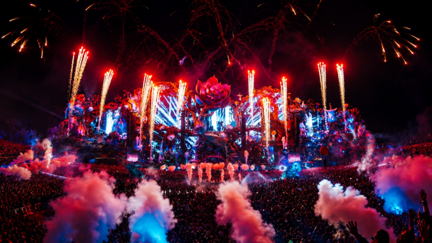 Tomorrowland's massive ornate Mainstage lights up at dusk with pyrotechnics and lasers as a huge crowd fills the Holy Grounds at De Schorre in Boom, Belgium.