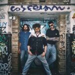 London trio Dead Horse pose in a graffiti-covered doorway, promoting their single 'I Would Die' from debut album 'Caught The Nonsense.'