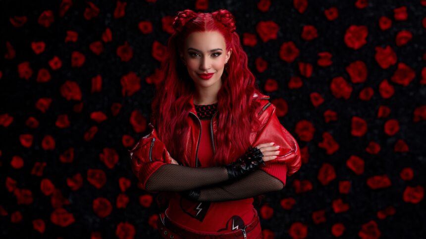 Kylie Cantrall poses with vibrant red hair styled in space buns, wearing a red leather jacket