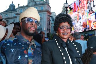 Fugees bandmates Wyclef Jean and Lauryn Hill, who say new music is coming, appear together at a London event near Piccadilly Lights.