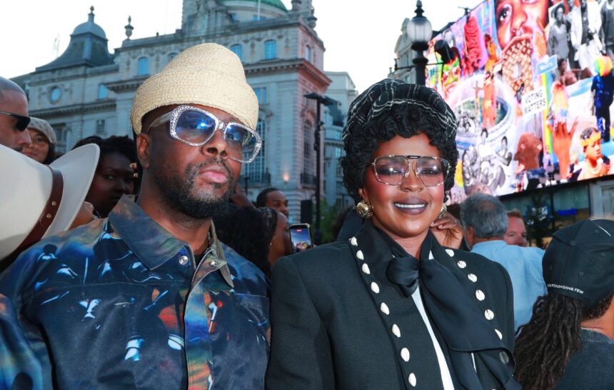 Fugees bandmates Wyclef Jean and Lauryn Hill, who say new music is coming, appear together at a London event near Piccadilly Lights.